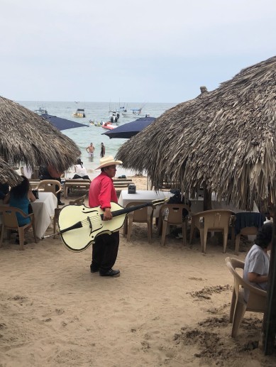 I found the owner! Major props to this guy for schlepping that bass around the beach in long sleeves and pants. That's one hot gig!
